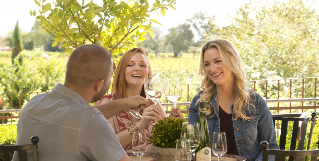 a group of people sitting at a table with wine glasses