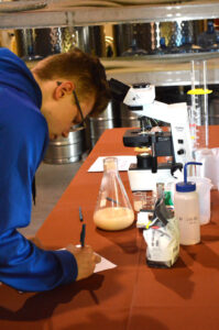 a person looking at a bottle of liquid