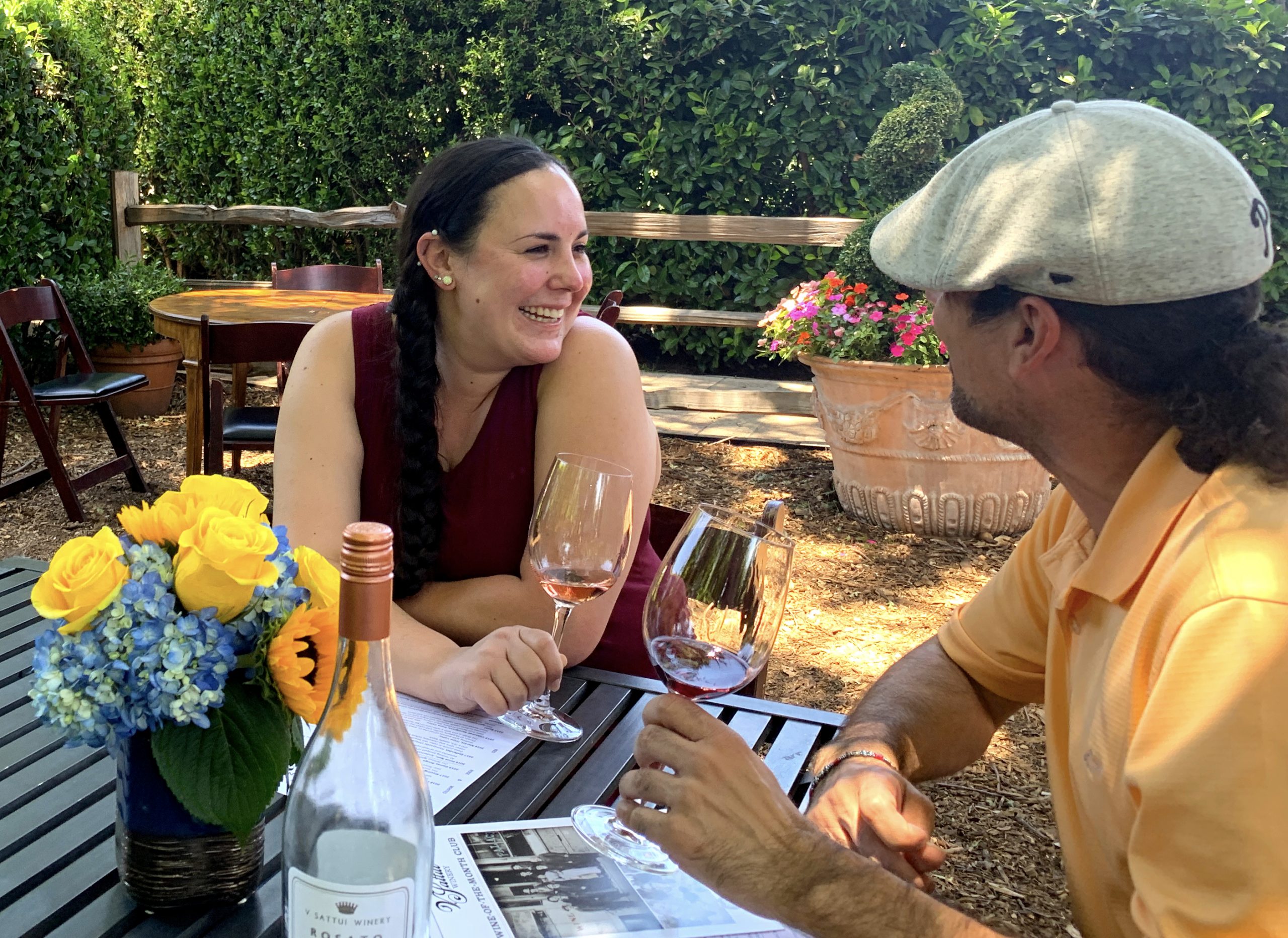 a man and a woman sitting at a table with wine glasses