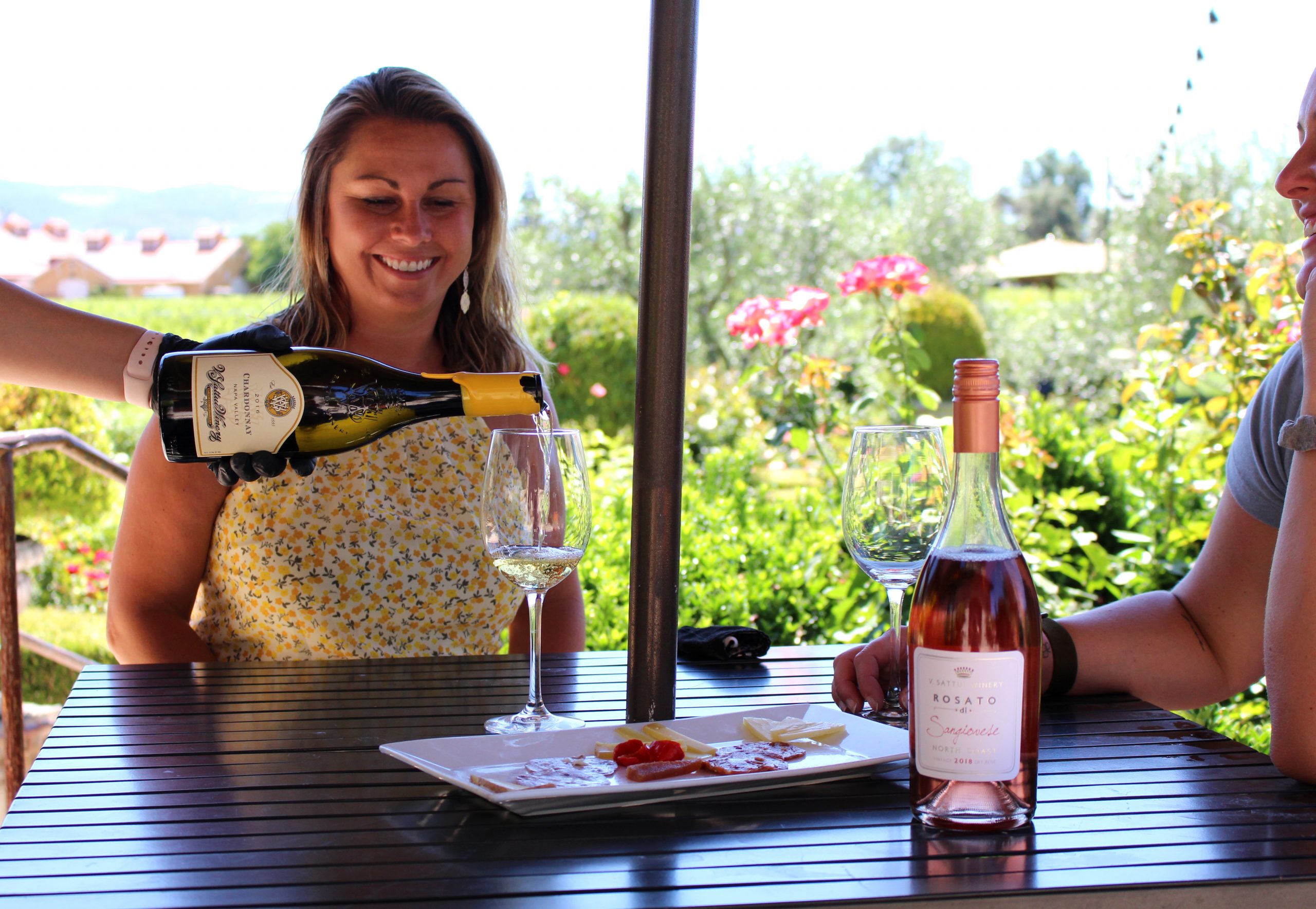 a woman holding a bottle of wine