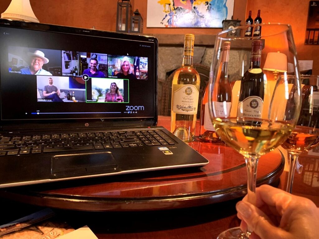 a laptop and wine glass on a table