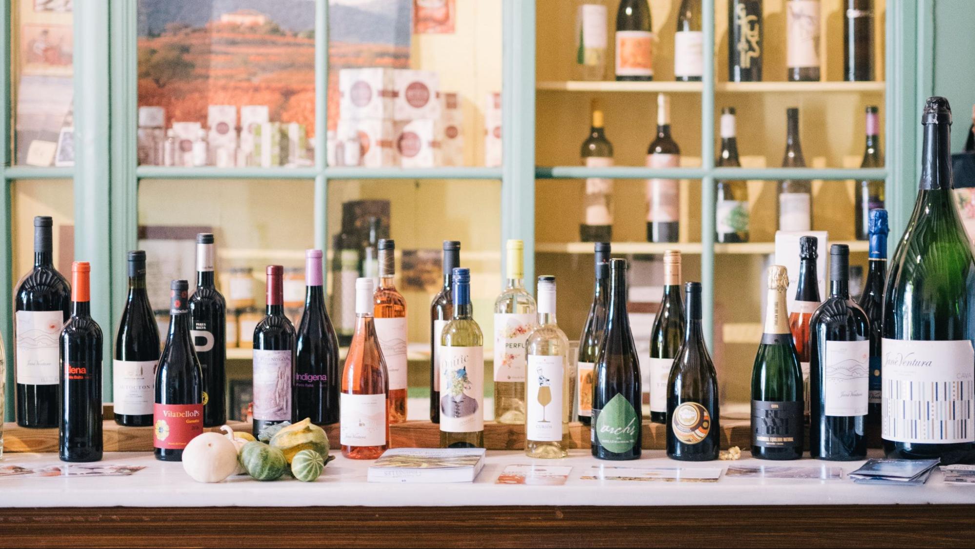 A bar counter full of different wines