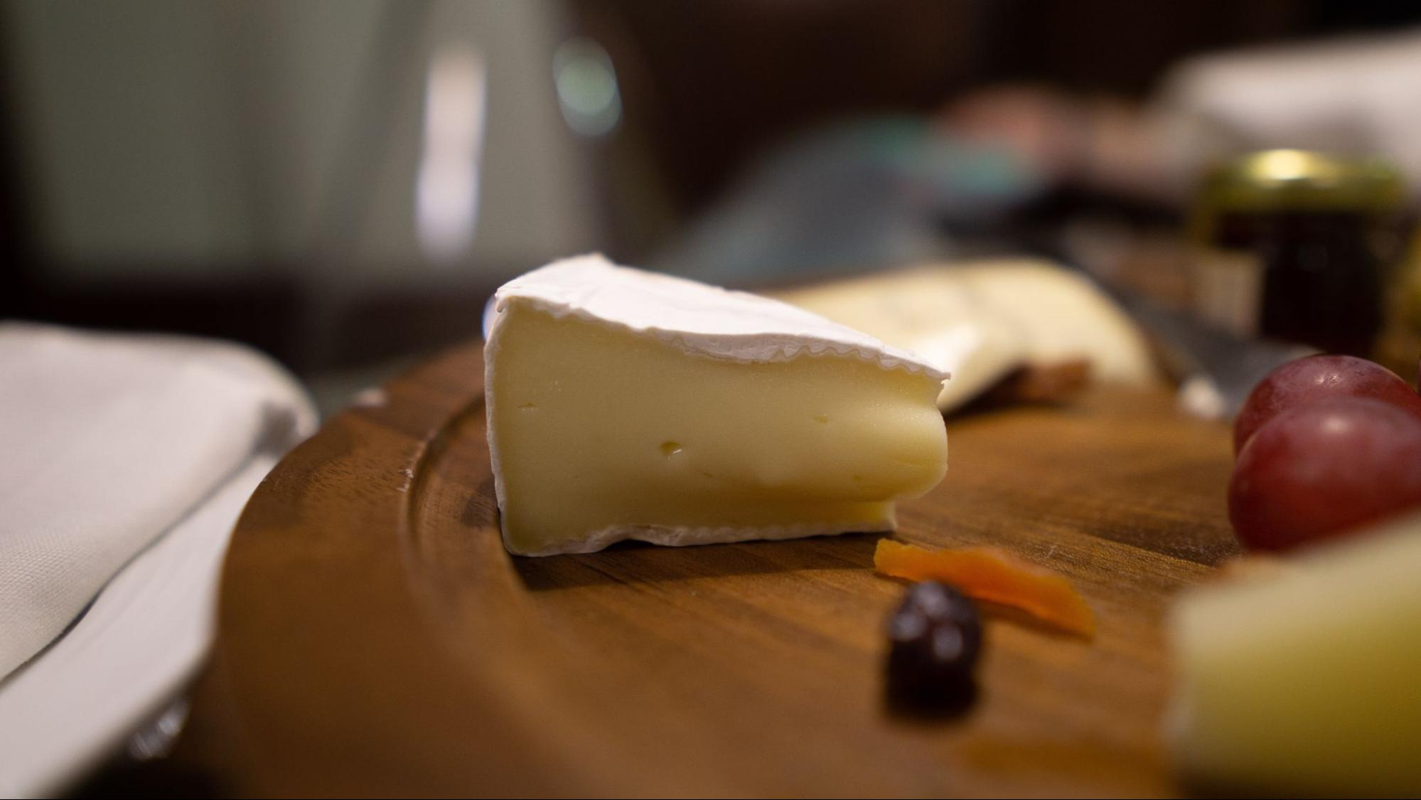 A slice of brie cheese, a great pairing for V. Sattui’s 2021 Los Carneros Chardonnay