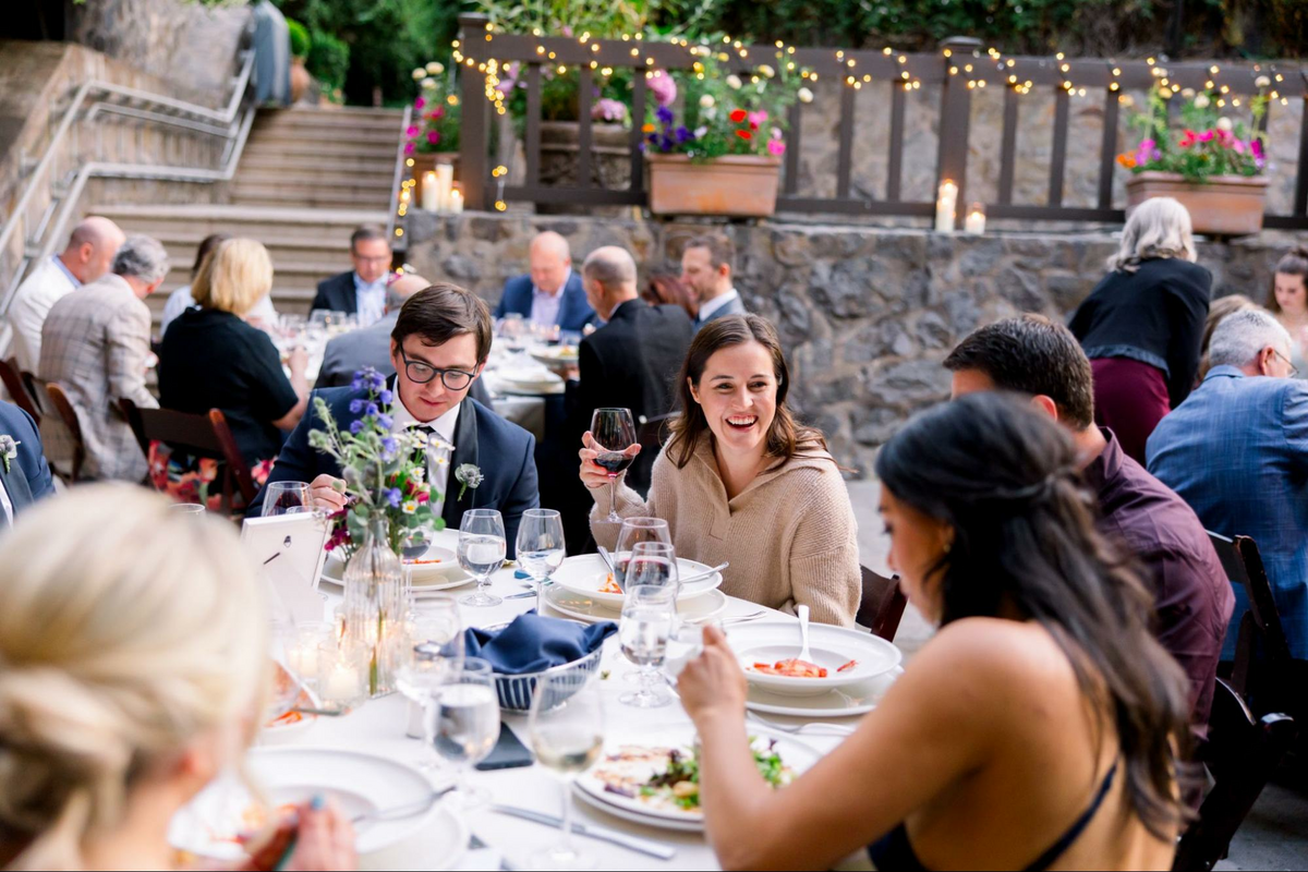 a group of people sitting around a dinner table