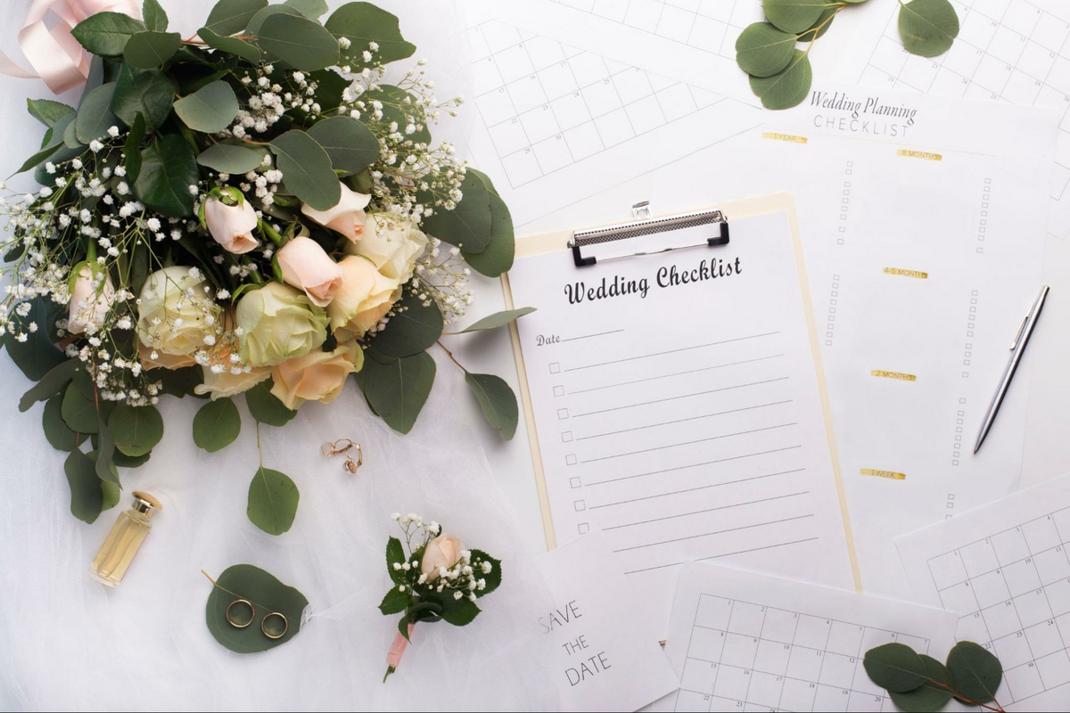 a bouquet of flowers next to a wedding checklist