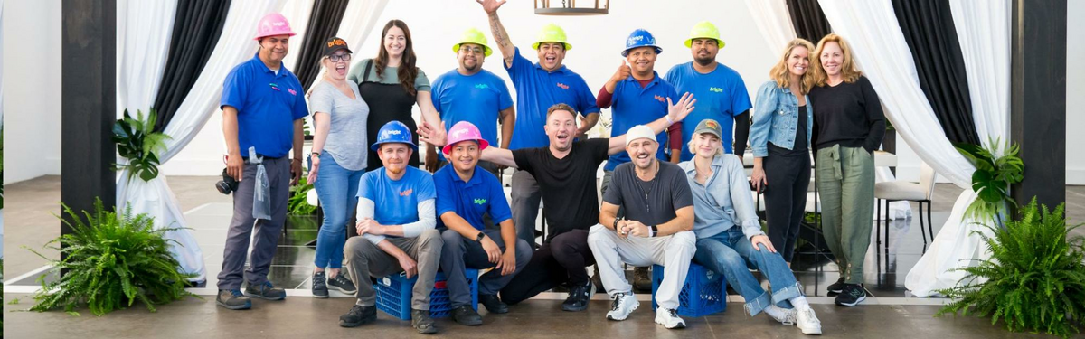 a group of people in blue shirts posing for a picture