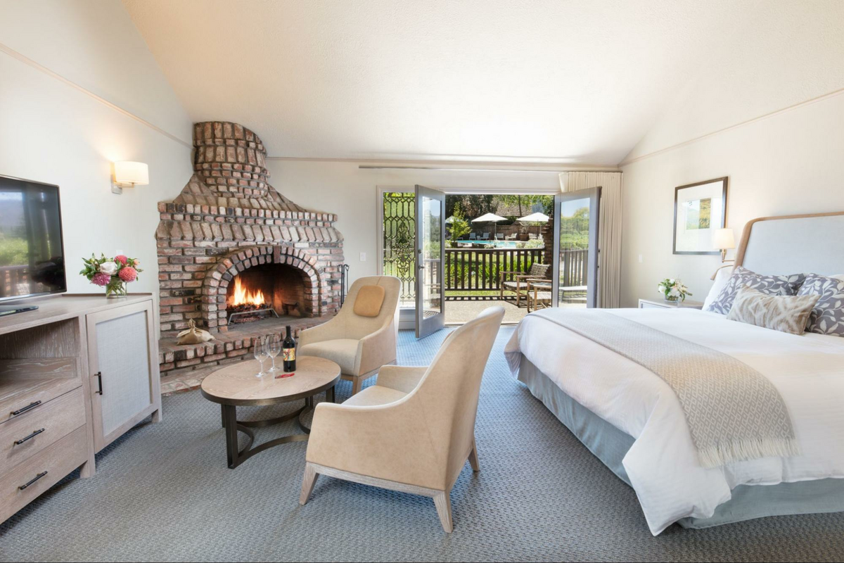 a bedroom with a fireplace and a bed