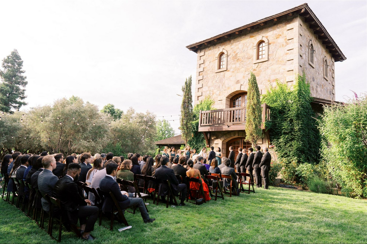 a group of people sitting in chairs in front of a building