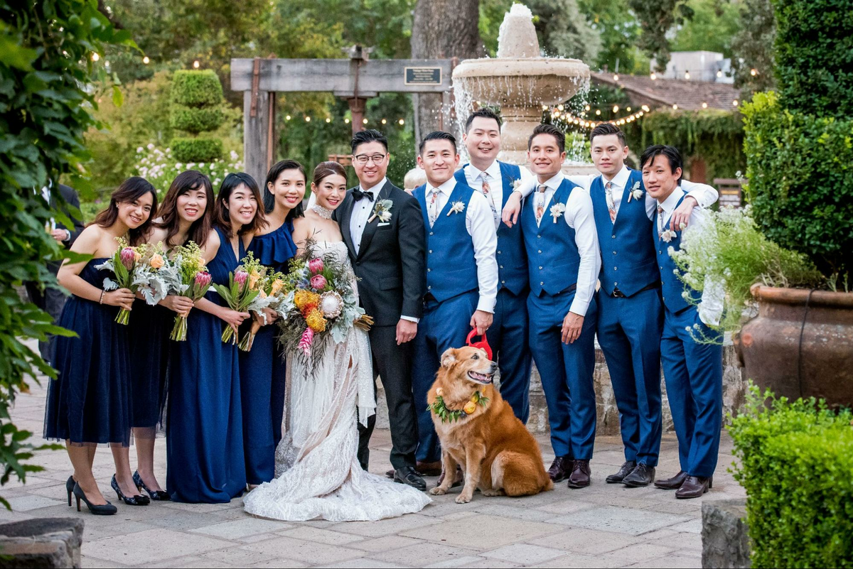 a group of people and a dog posing for a picture