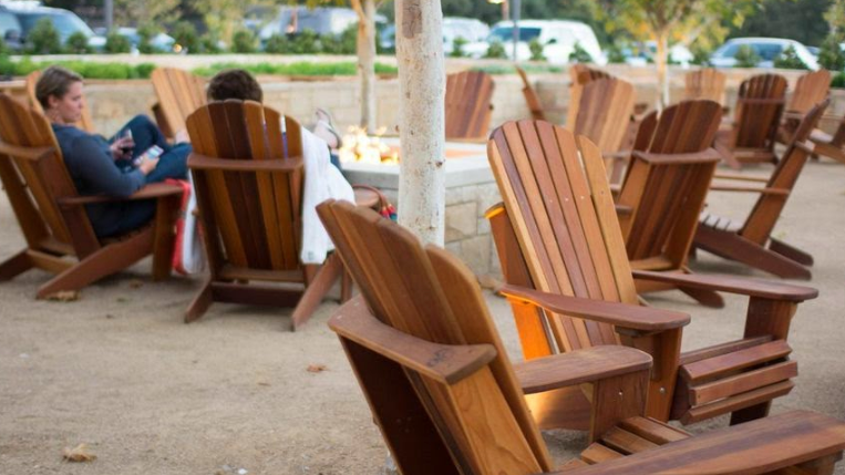 The outdoor seating area and stone fire pit at R+D Kitchen in Yountville, CA