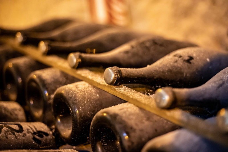bottles of sparkling wine in a cellar, as shown in the V. Sattui wine blog on Napa Valley sparkling wine