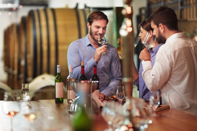 2 man and 1 woman with a set of wines in the table as they are tasting each wine, as featured in VSattui Winery